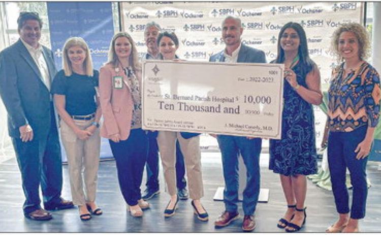 SBPH officials and council member at-large east Kerri Callais (far right) accept $10,000 grant from LAMMICO.