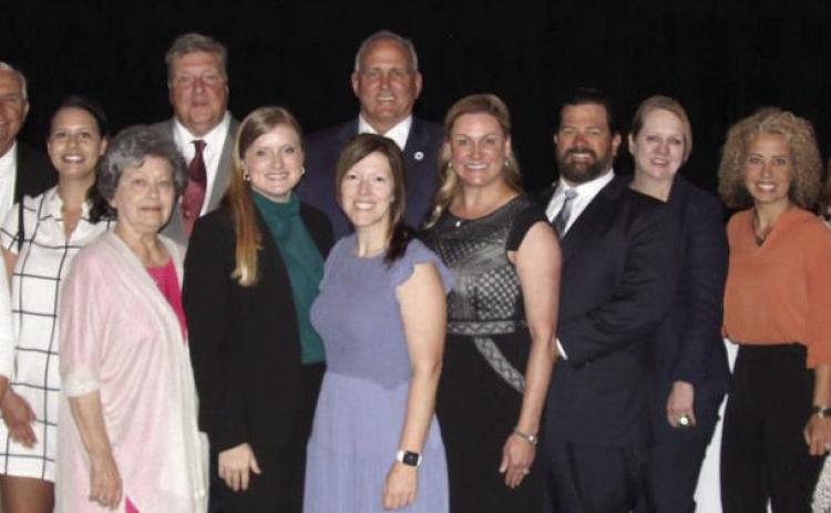 Members of the St. Bernard Chamber of Commerce and local government officials pose for a photo after the State of the Parish presentations.
