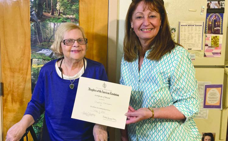Francois deLery Chapter, Daughters of the American Revolution, past Regent Gayle Buckley (R) recently presented former Chaplain Christine Morrison (L) with a certificate and pin for Excellence in Community Service. Christine hosts poetry writing sessions at her assisted living facility and does online work with the Franciscans. Christine is a former resident of Chalmette.