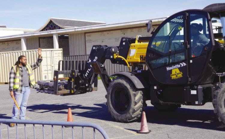 Heavy Equipment students practice operating and directing a telescoping forklift on the Nunez campus.