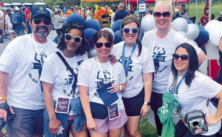 Community Center of St. Bernard's Board Members and sta enjoying the post-race afterparty at the 2024 Crescent City Classic. Photo Credit: Lori Noto
