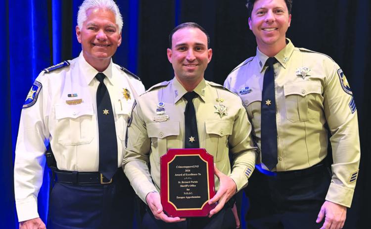 St. Bernard Sheri James Pohlmann, left, stands with Special Investigations Division Sgt. Richard Scheuermann, center, and Sgt. Jonathan Smith, right, after they were honored at the 41st Annual CrimestoppersGNO Awards Luncheon for their partnership in handling anonymous tips that developed into critical intelligence assisting in the arrest of Orleans Parish Prison escapees.
