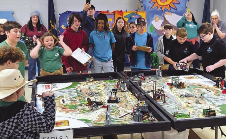 Students from Nunez Community College Robotics Team 57245, in black, and Our Lady of Prompt Succor (OLPS) School’s Patriots, in green, participate in the college’s inaugural FIRST LEGO League Tournament in December 2025. Three Nunez teams and OLPS advanced to state competition in February at Jesuit High School.