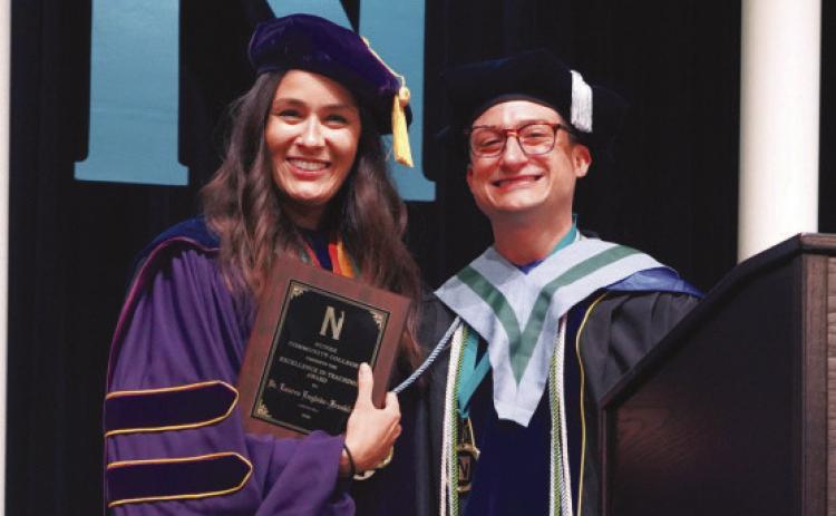 Dr. Lauren Englade-Franklin, professor of chemistry, is presented with Nunez Community College’s 2026 Excellence In Teaching Award May 20 during Nunez’s 34th Commencement Ceremony at the Sigur Center in Chalmette. Dr. Franklin was presented with the award onstage by the 2025 winner, Dr. Charles Miller, associate professor of sociology.