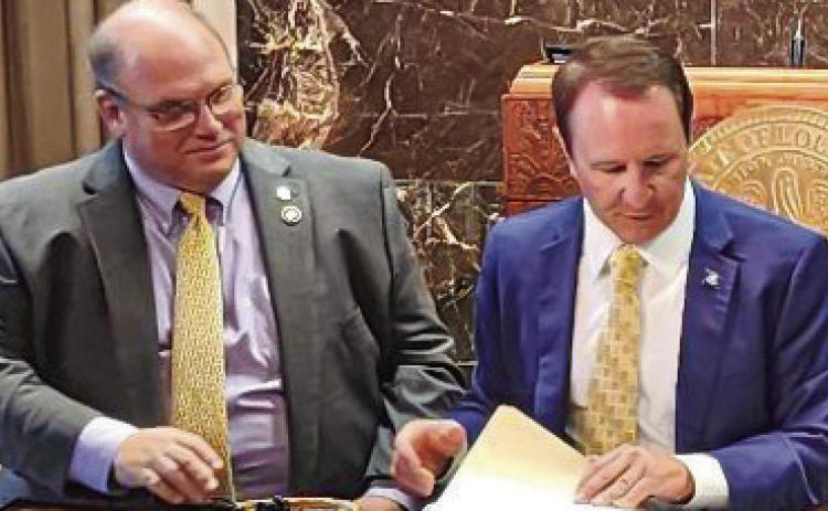 House Representative Mike Bayham gets first bill signed into law by Governor Jeff Landry.