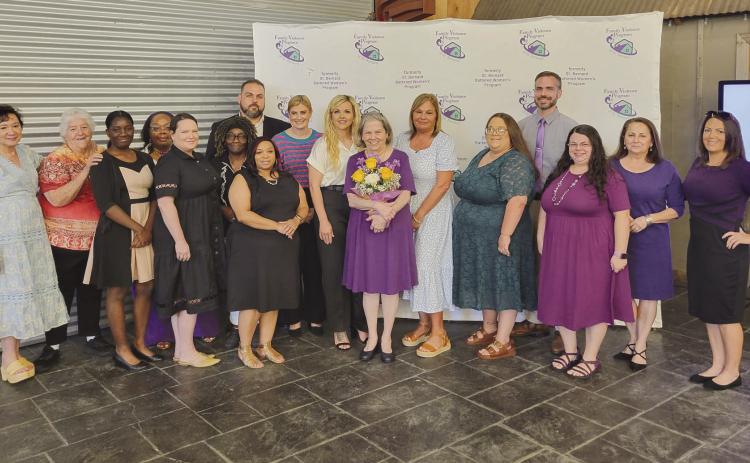 Gail Gowland was given . owers as a show of appreciation for her decades of service by her colleagues and friends at Healing in Bloom, a luncheon for the Family Violence Program of St. Bernard.